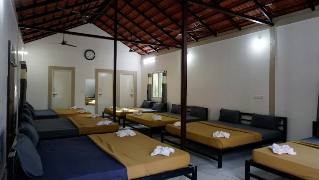 The family room, with beds in rows under a tiled roof