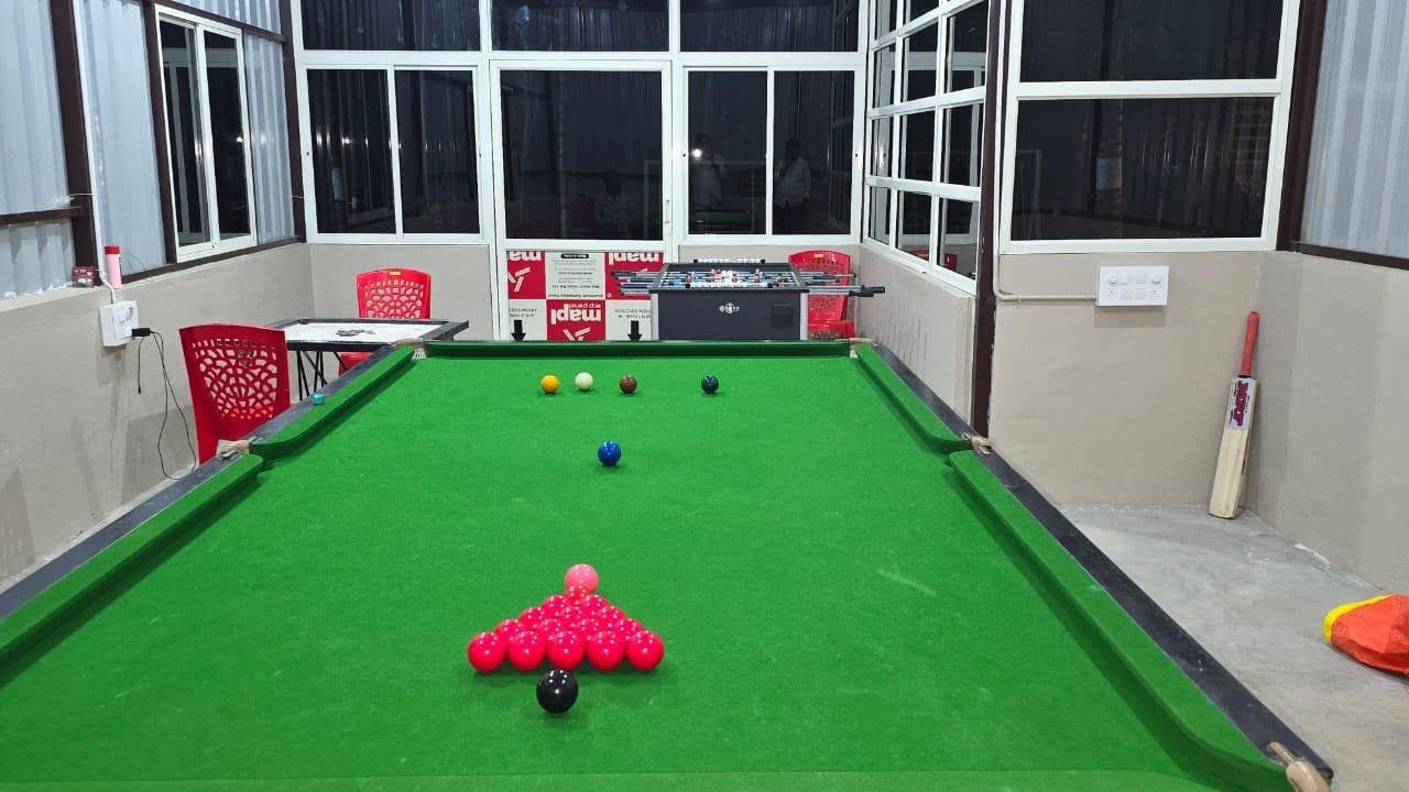 The indoor games room with a snooker table